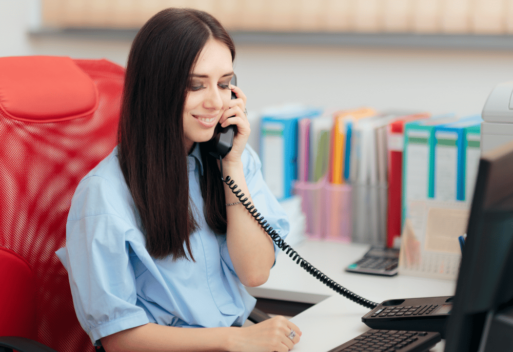 A charity fundraising team employee on the phone to a supporter, representing how to generate income for a charity.