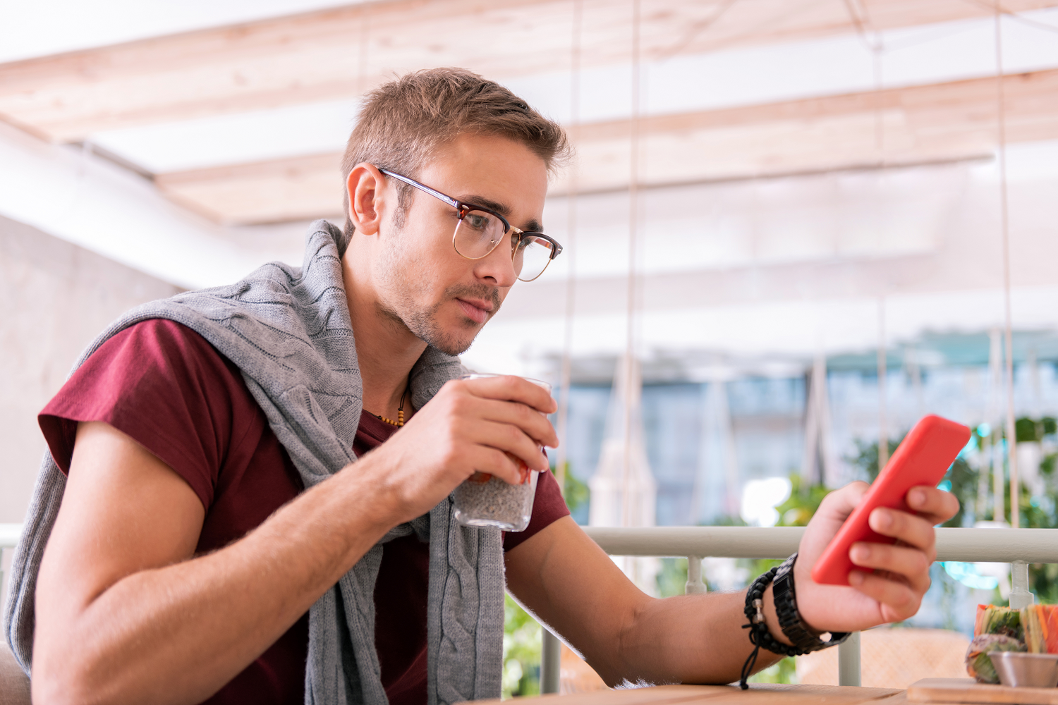 A man checking emails on his phone, representing email as a direct marketing tool for your charity