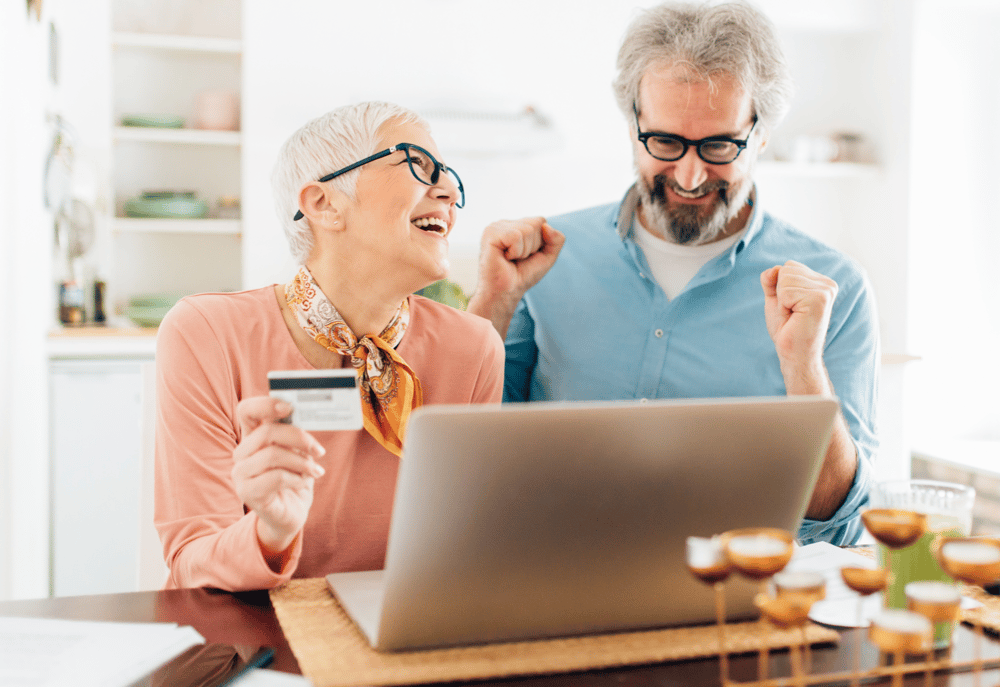 A senior couple signing up to an online charity lottery, representing the impact of working with online lottery providers.