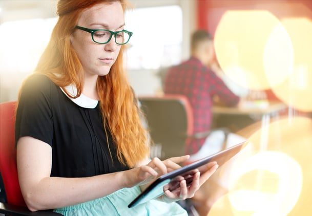 Confident female designer working on a digital tablet in red creative office space-2