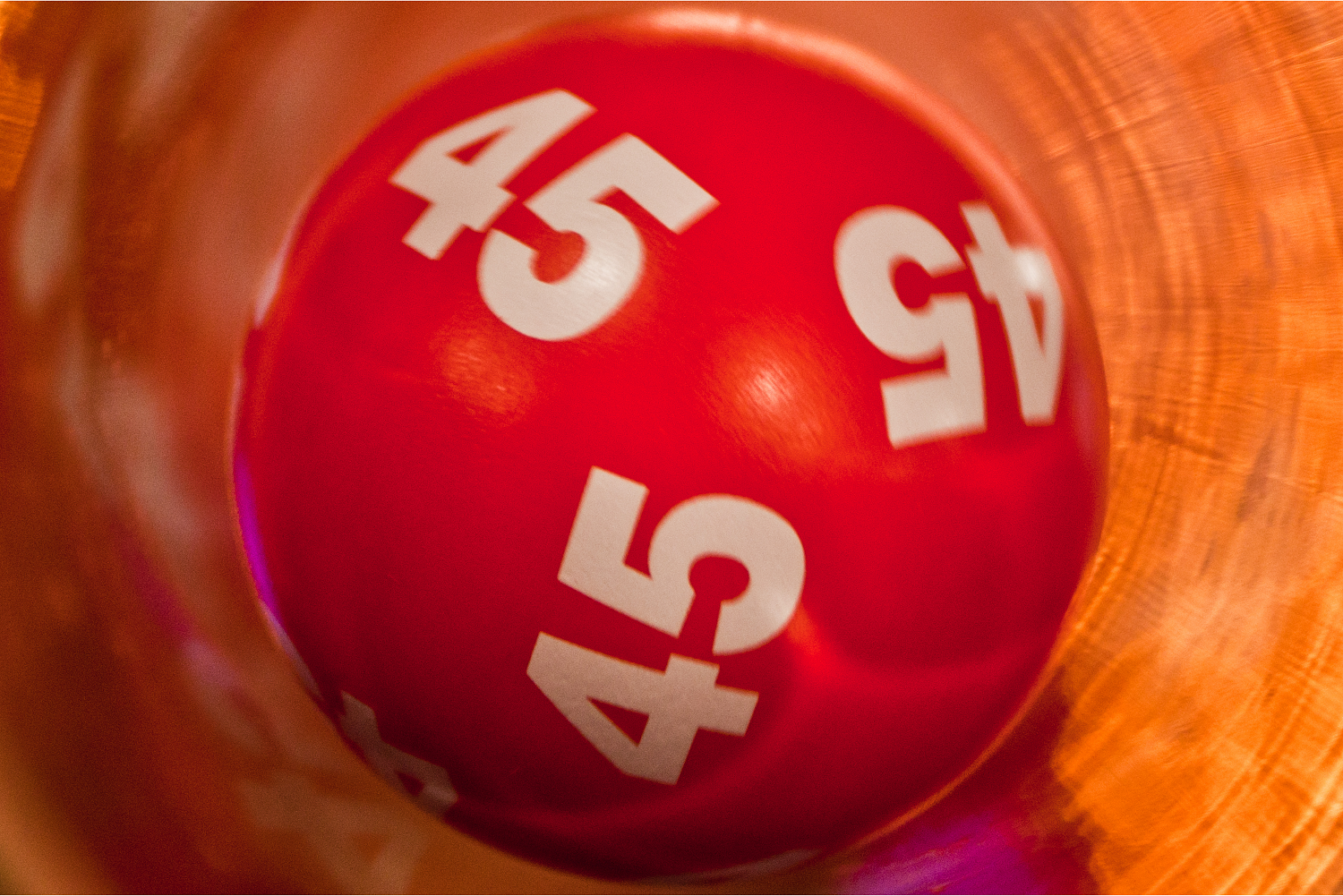 Red lottery ball with the number 45, representing charity lottery providers