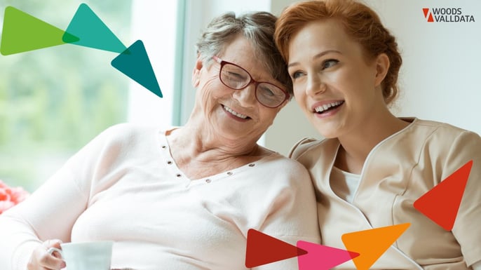 older lady sitting with young carer smiling and sharing a moment WV Brand