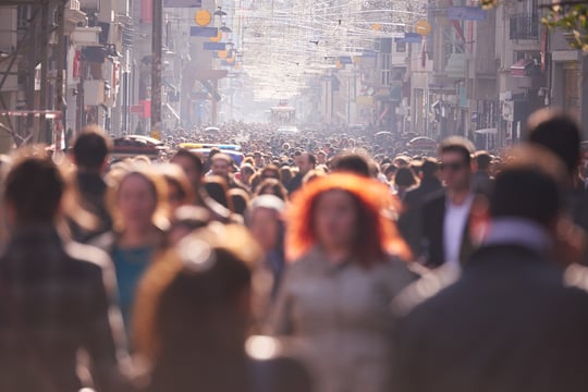 people crowd walking on busy street on daytime showing the multitude of potential audiences for prize-led fundraising